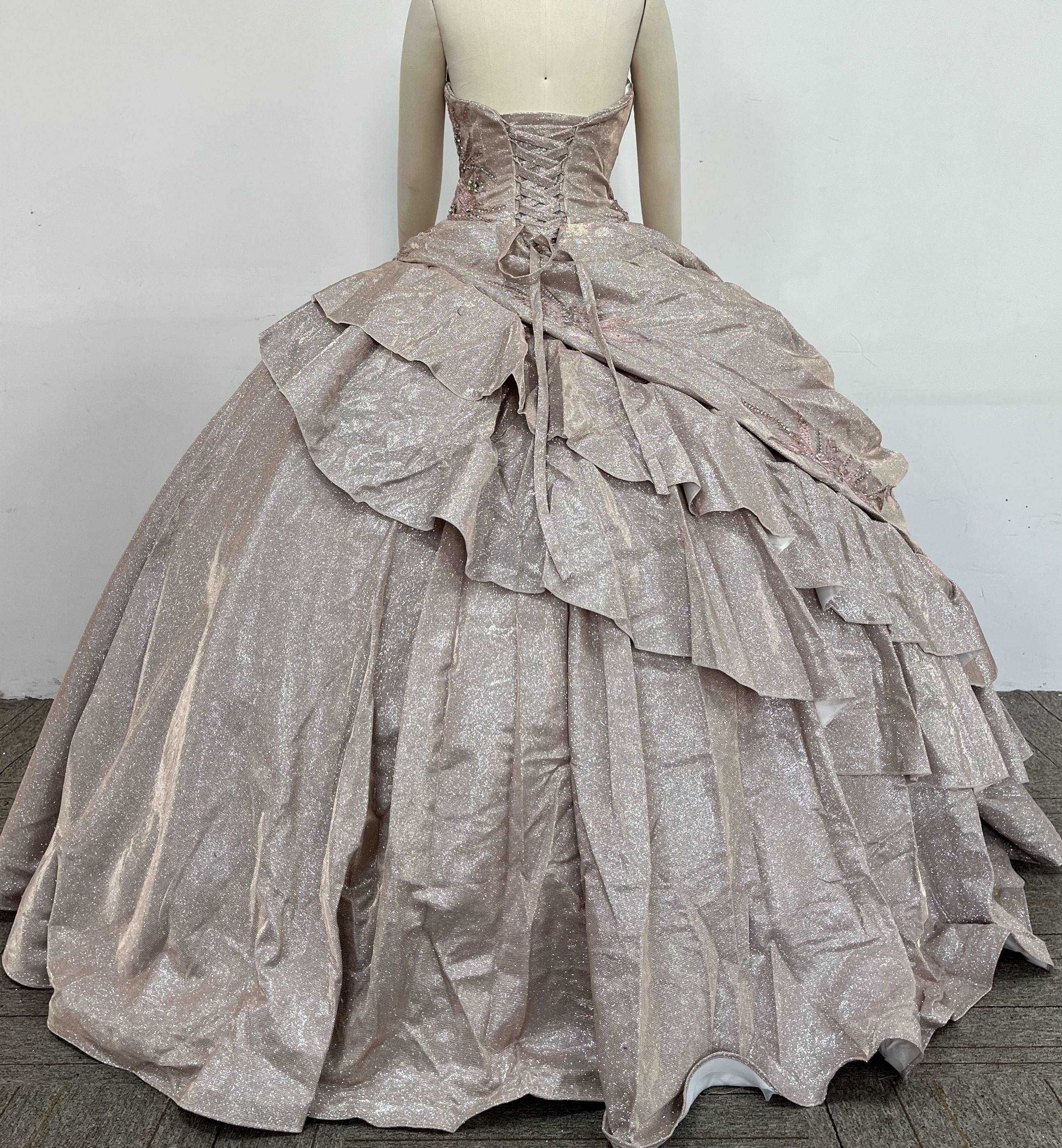 A beautiful gown, off-shoulder, reveals noble air.