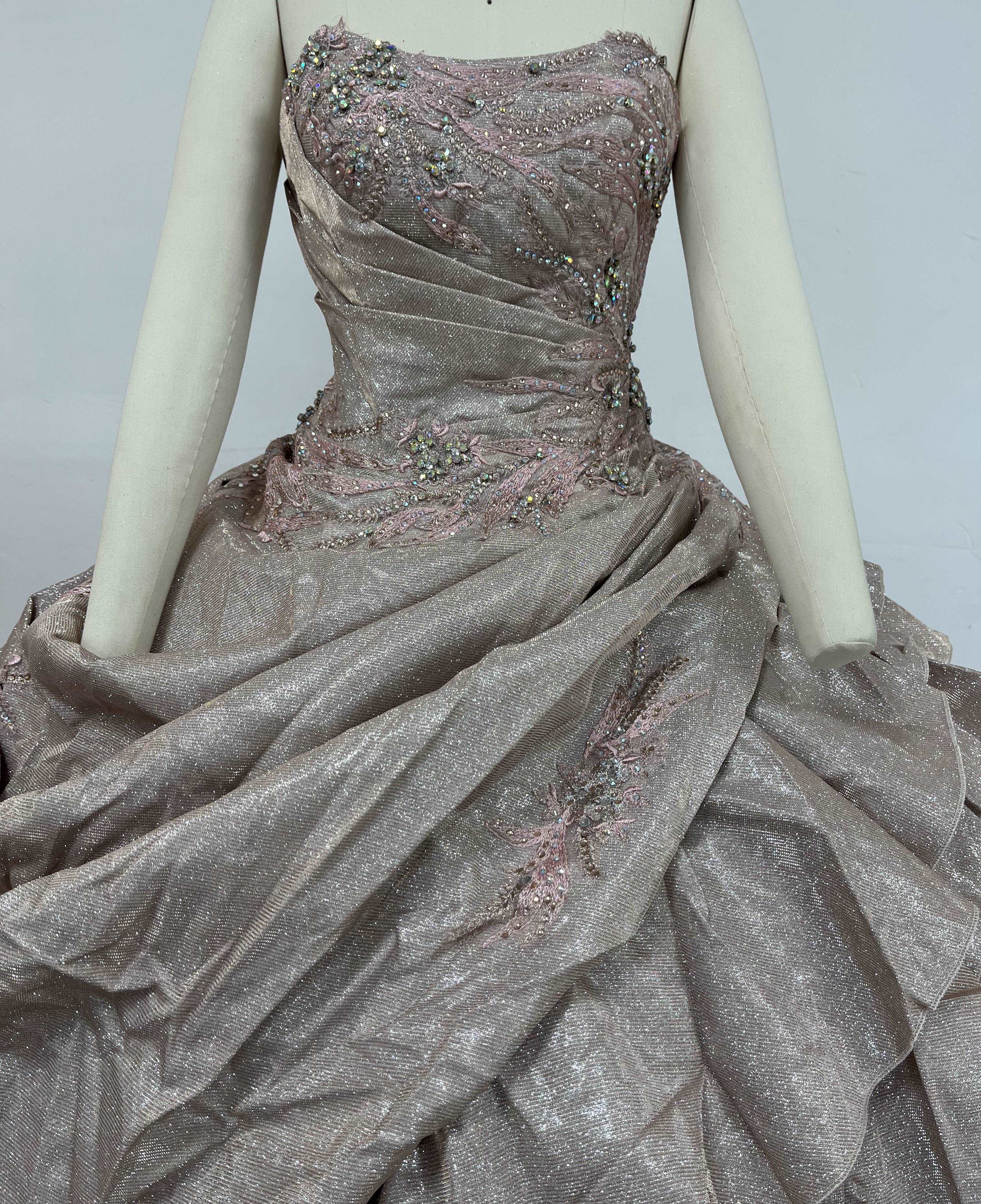 A beautiful gown, off-shoulder, reveals noble air.