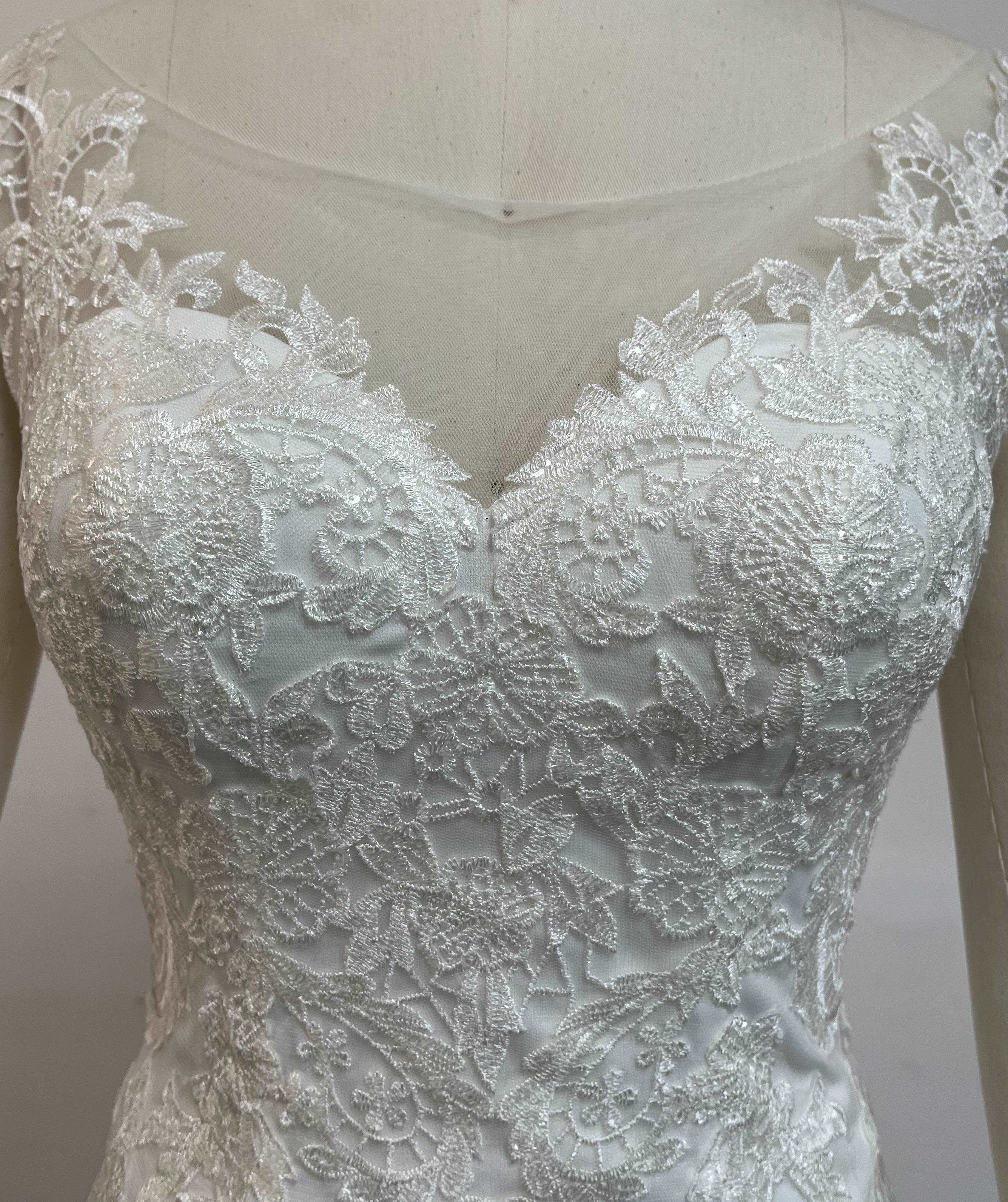Fashionable minimalist handmade embroidered lace wedding dress.
