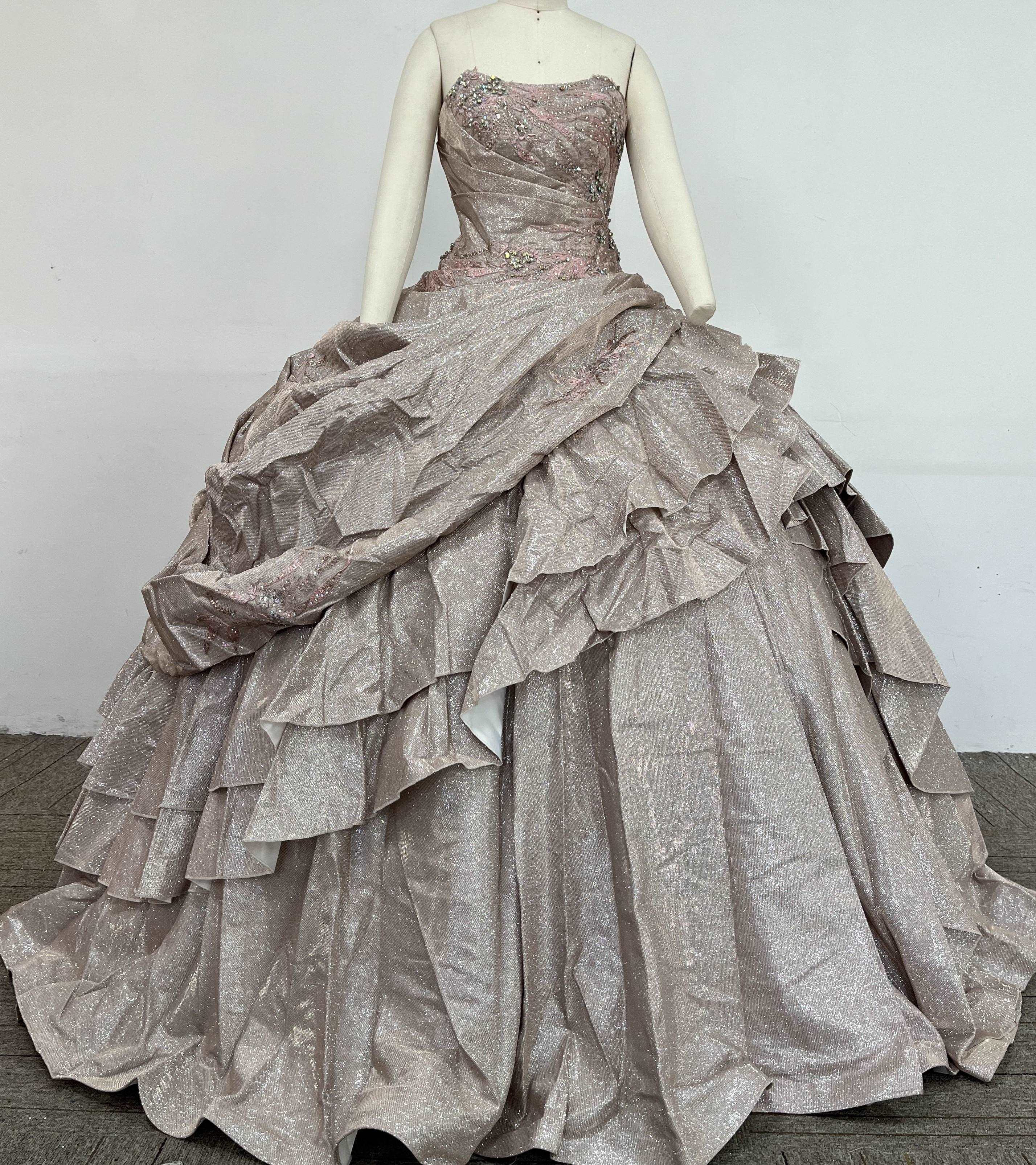 A beautiful gown, off-shoulder, reveals noble air.