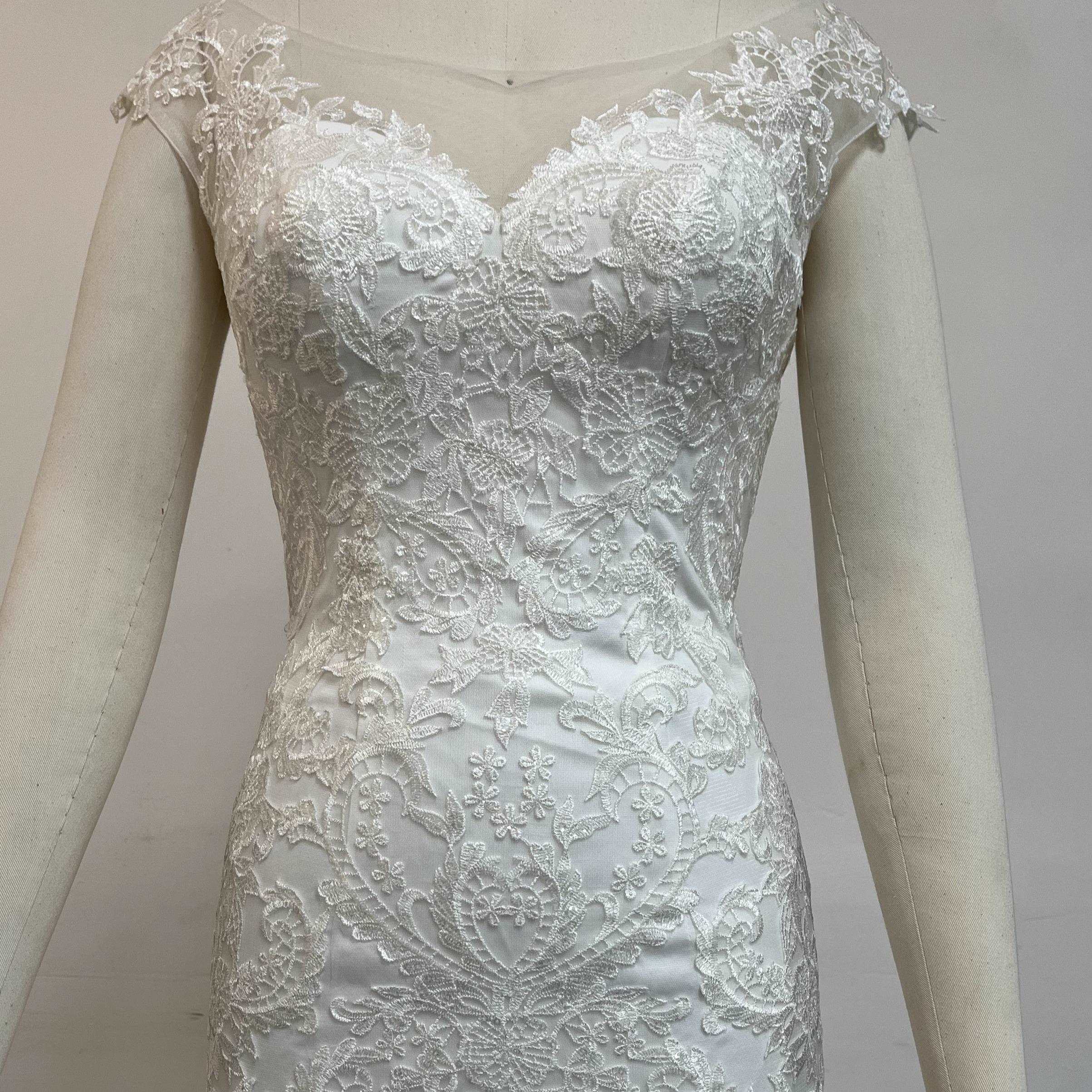 Fashionable minimalist handmade embroidered lace wedding dress.
