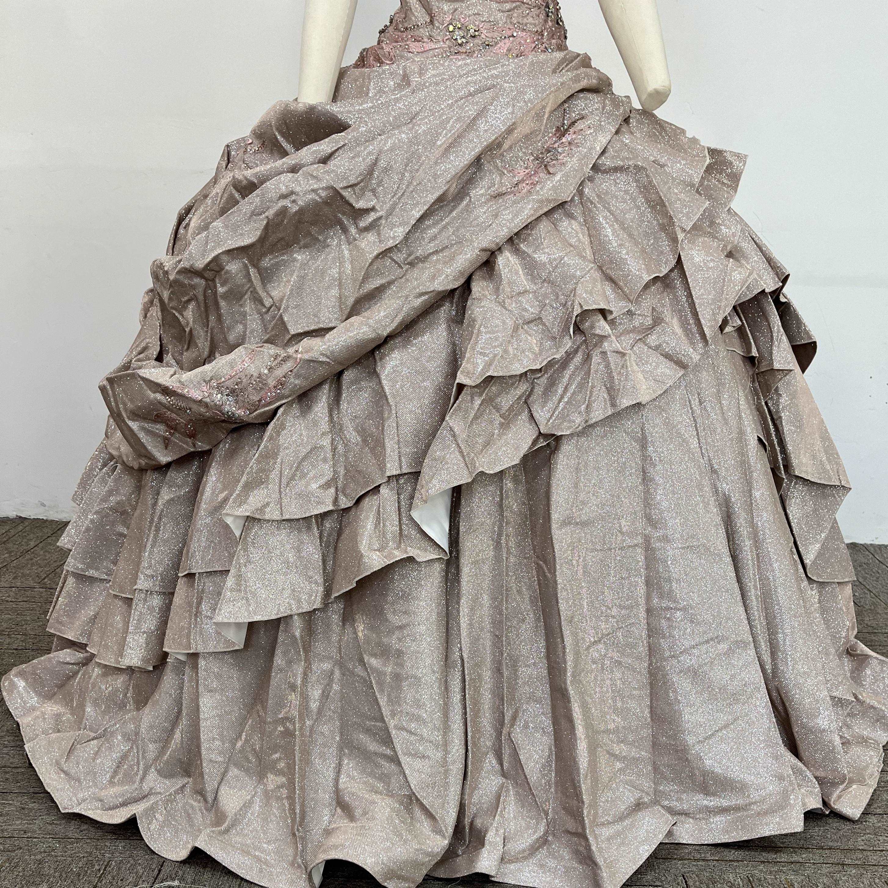 A beautiful gown, off-shoulder, reveals noble air.