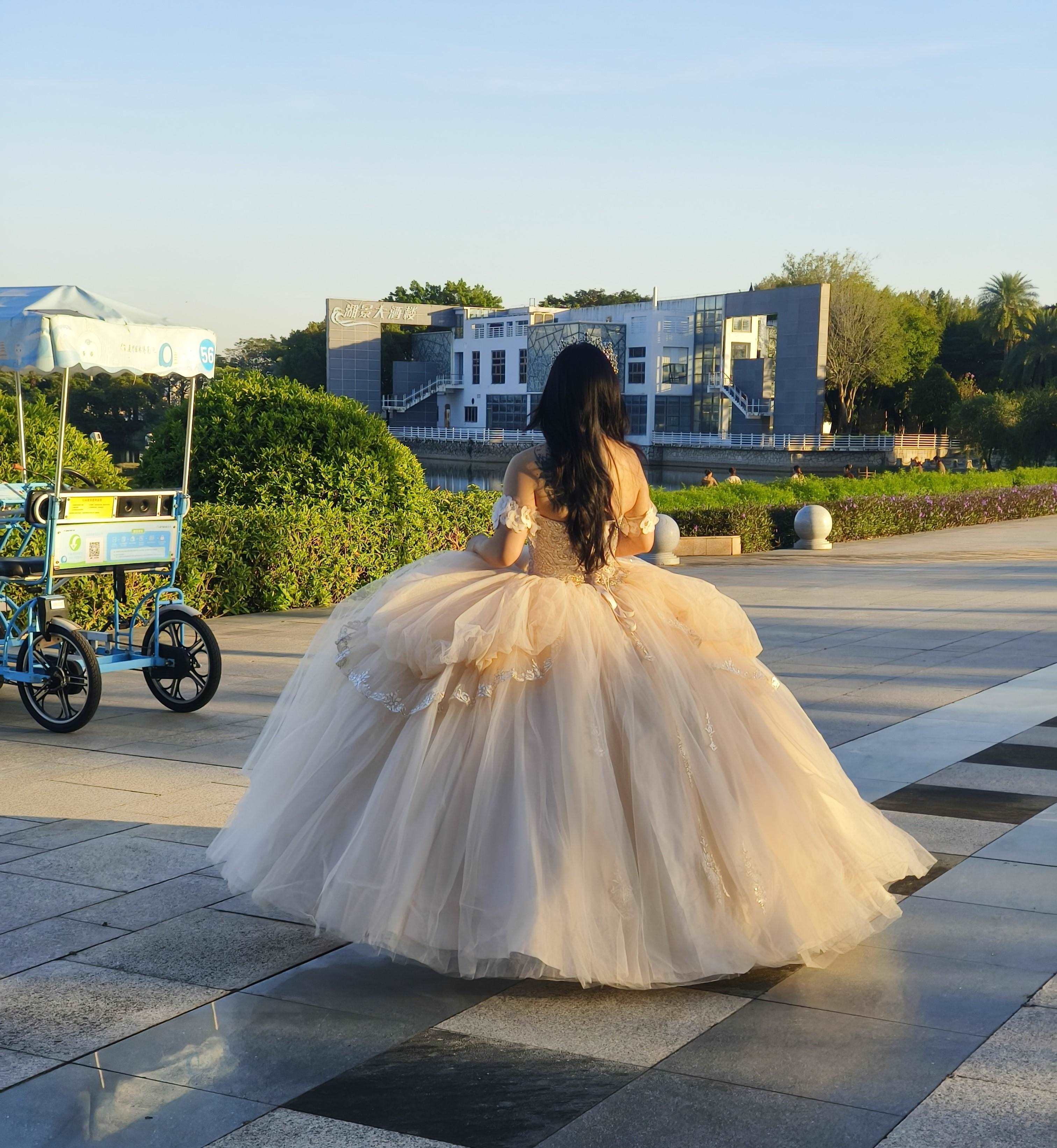 Adults in gowns, flowing skirts, confident display.