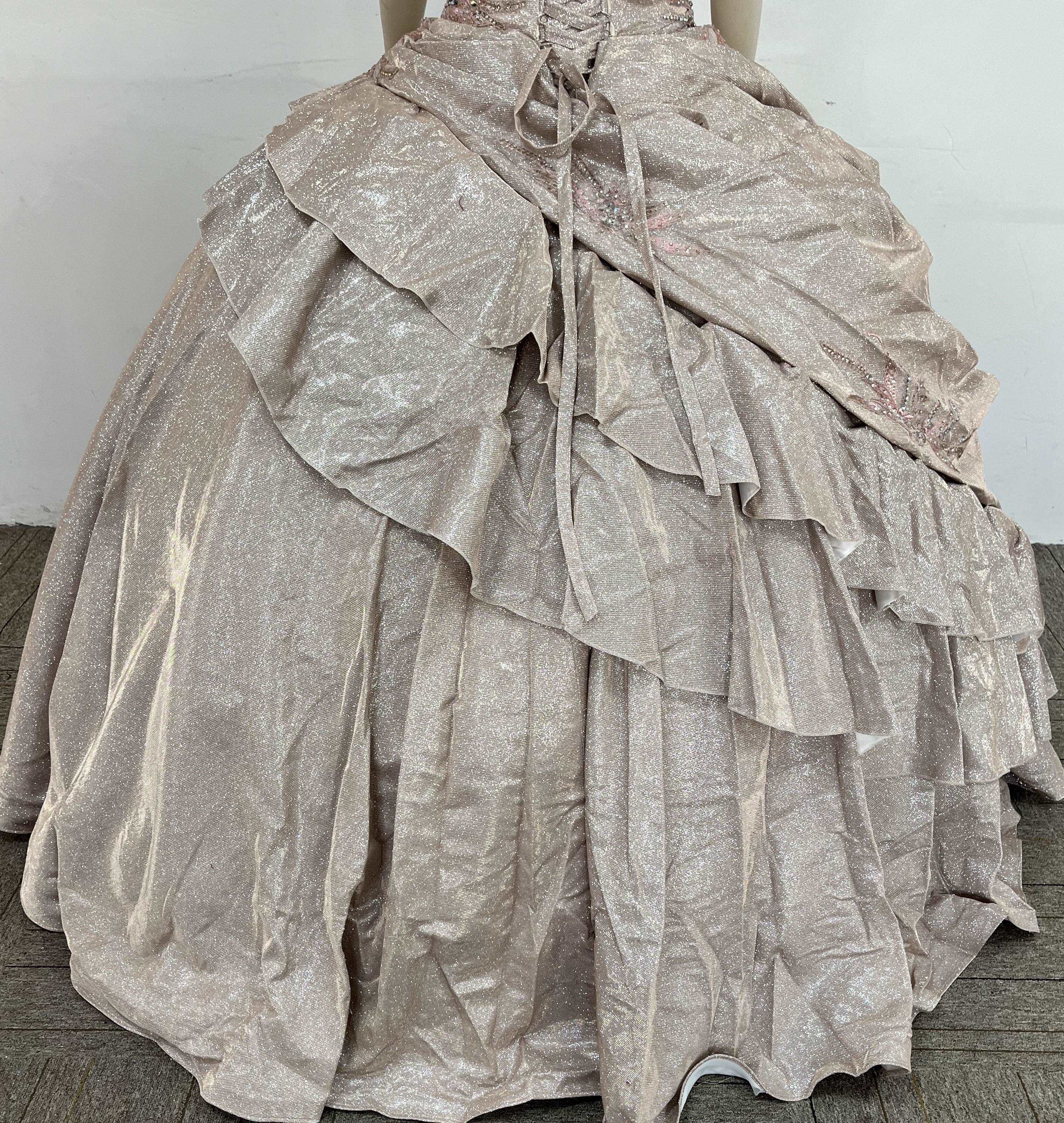 A beautiful gown, off-shoulder, reveals noble air.